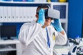 Young latin man scientist using virtual reality glasses at laboratory Royalty Free Stock Photo