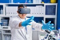 Young latin man scientist using virtual reality glasses at laboratory Royalty Free Stock Photo