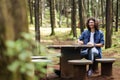 Young latin man sitting in the forest closing laptop smiling at Costa Rica Royalty Free Stock Photo