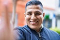 Young latin man smiling confident making selfie by camera at street Royalty Free Stock Photo