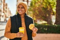 Young latin man smiling happy having breakfast at the city