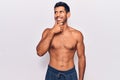 Young latin man standing shirtless with hand on chin thinking about question, pensive expression Royalty Free Stock Photo