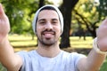 Young latin man taking a selfie in a park. Royalty Free Stock Photo