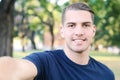 Young latin man taking a selfie in a park. Royalty Free Stock Photo