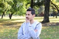 Young latin man thoughtful in a park. Royalty Free Stock Photo