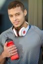 Young latin man water bottle runner portrait format running sports training fitness Royalty Free Stock Photo