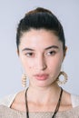 Close up of a eautiful woman portrait with rounded necklace and earrings