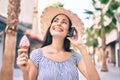 Young latin tourist girl on vacation talking on the smartphone eating ice cream at the city Royalty Free Stock Photo