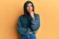 Young latin transsexual transgender woman wearing casual clothes serious face thinking about question with hand on chin, Royalty Free Stock Photo