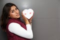 Young latin woman with box of heart chocolates. Valentine`s Day Royalty Free Stock Photo