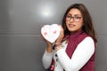 Young latin woman with box of heart chocolates. Valentine`s Day Royalty Free Stock Photo