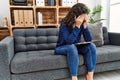 Young latin woman depressed having psychology session at psychology center Royalty Free Stock Photo