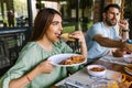 Young latin woman eating mexican tacos on a restaurant terrace in Mexico Latin America, feeling happy on a summer day Royalty Free Stock Photo