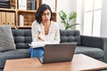 Young latin woman having psychology online session using laptop at psychology center