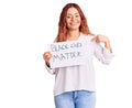 Young latin woman holding black lives matter banner pointing finger to one self smiling happy and proud Royalty Free Stock Photo