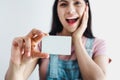 Young latin woman holding a blank empty card isolated on white background in Latin America Royalty Free Stock Photo