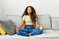 Young latin woman relaxed doing yoga exercise at home Royalty Free Stock Photo