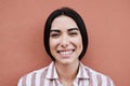 Young latin woman smiling on camera outdoors in the city - Focus on face Royalty Free Stock Photo