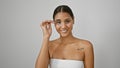 Young latin woman smiling confident combing eyebrows with brush over isolated white background