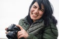 young latin woman smiling with her digital camera creating content for her social networks outdoors Royalty Free Stock Photo