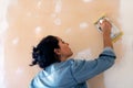 Young latin woman smooths a plastering indoor wall Royalty Free Stock Photo