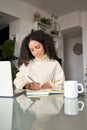 Young latin woman student using laptop elearning or working at home. Royalty Free Stock Photo