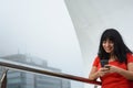 young latin woman tourist in buenos aires, sending message on her mobile phone outdoors Royalty Free Stock Photo