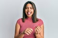Young latin woman using file nail sticking tongue out happy with funny expression Royalty Free Stock Photo