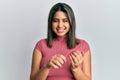 Young latin woman using file nail winking looking at the camera with sexy expression, cheerful and happy face Royalty Free Stock Photo