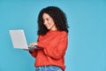 Young latin woman using laptop computer isolated on blue background. Royalty Free Stock Photo