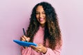 Young latin woman using touchpad writing on screen winking looking at the camera with sexy expression, cheerful and happy face Royalty Free Stock Photo