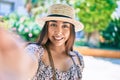 Young latin woman on vacation smiling happy making selfie by the camera at street of city Royalty Free Stock Photo