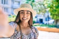 Young latin woman on vacation smiling happy making selfie by the camera at street of city Royalty Free Stock Photo