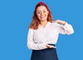 Young latin woman wearing waitress apron gesturing with hands showing big and large size sign, measure symbol Royalty Free Stock Photo