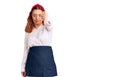 Young latin woman wearing waitress apron looking unhappy and angry showing rejection and negative with thumbs down gesture Royalty Free Stock Photo