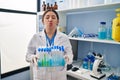 Young latin woman working at scientist laboratory looking at the camera blowing a kiss being lovely and sexy Royalty Free Stock Photo