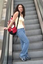 Young Latina student on escalator