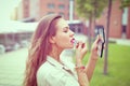 Young Latina woman applying lipstick before dating Royalty Free Stock Photo