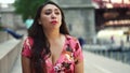 Young Latina woman at Chicago River Walk is having an exciting conversation