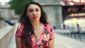 Young Latina woman at Chicago River Walk is having an exciting conversation