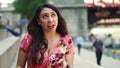 Young Latina woman at Chicago River Walk is having an exciting conversation