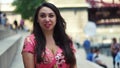 Young Latina woman at Chicago River Walk is having an exciting conversation