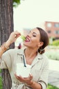 Young Latina woman enjoying eating fresh lettuce at park Royalty Free Stock Photo