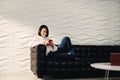 Young Hispanic Girl Messaging With Cell Phone On Sofa Royalty Free Stock Photo