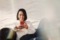 Young Hispanic Girl Messaging With Cell Phone On Sofa Royalty Free Stock Photo