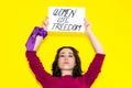 woman with a purple scarf on her wrist holding a sign reading WOMEN LIFE FREEDOM. Concept of women's equality. Women Royalty Free Stock Photo