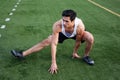 Young latino male athlete stretching
