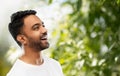 Young laughing indian man over natural background