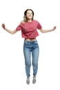 Young laughing jumping girl in a red tank top and jeans. Happy time. Isolated on a white background. Vertical