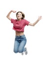 Young laughing jumping girl in a red tank top and jeans. Happy time. Isolated on a white background. Vertical